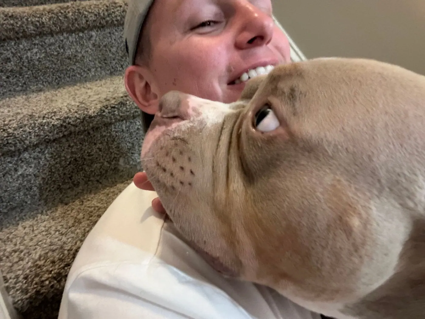 Hooman on Demand dog walker getting a hug from a pit bull
