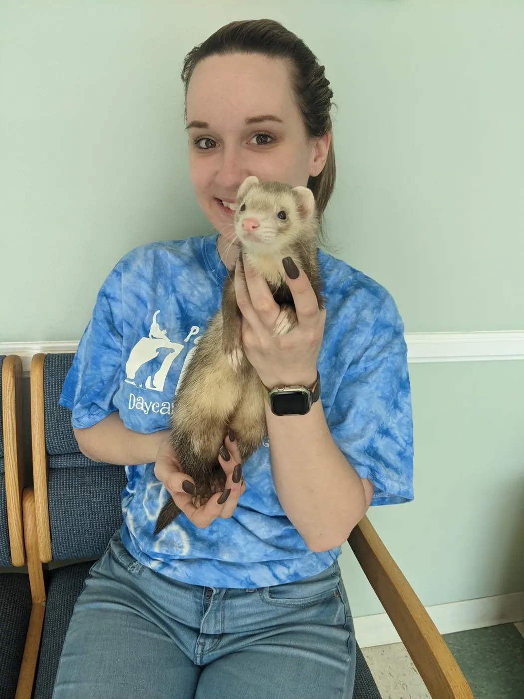 Sam, a Hooman on Demand pet sitter, holding a ferret